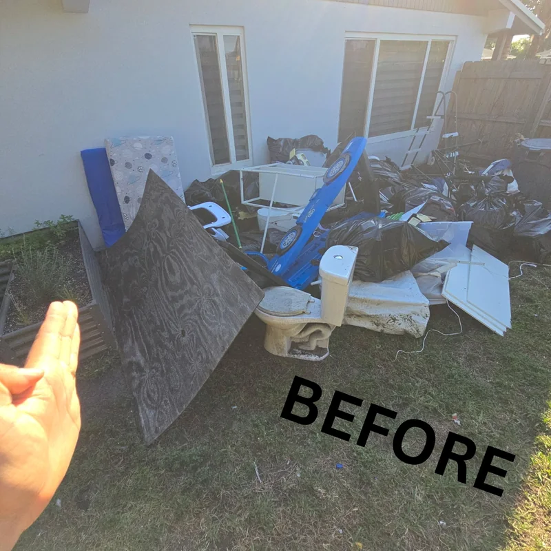 Residential items collected near a driveway before removal