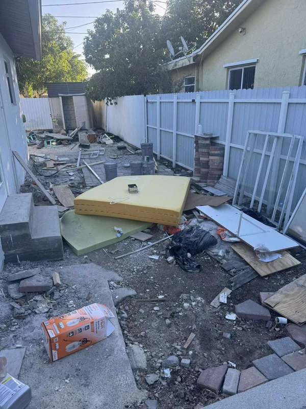 Residential debris and household material staged outside for removal